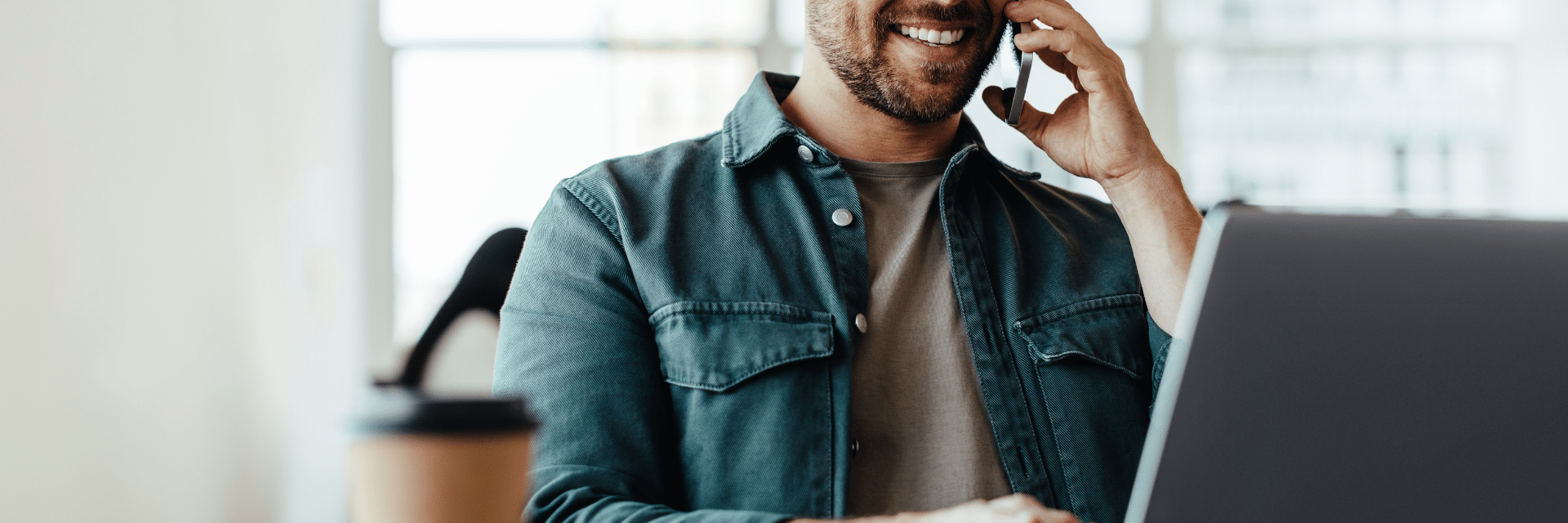 business man sitting in front of a laptop
